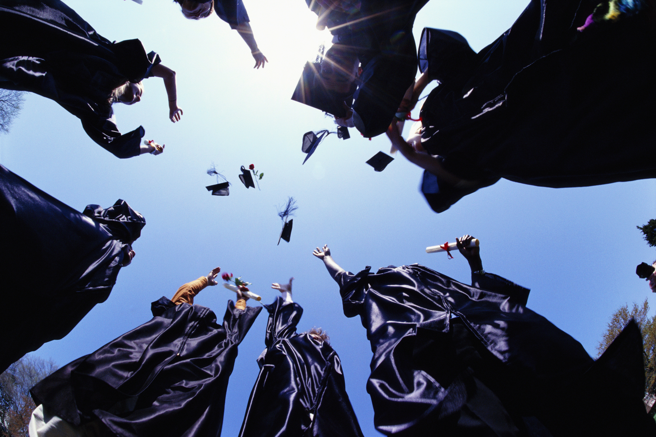 Graduates throw caps in the air