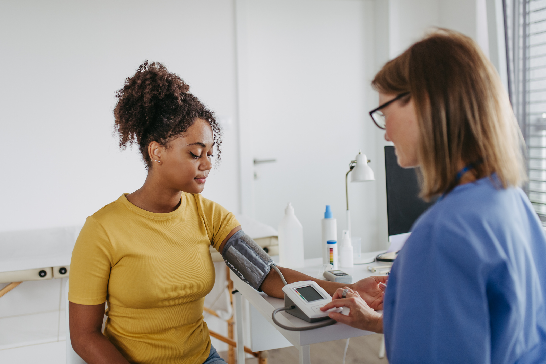Doctor checking patient blood pressure