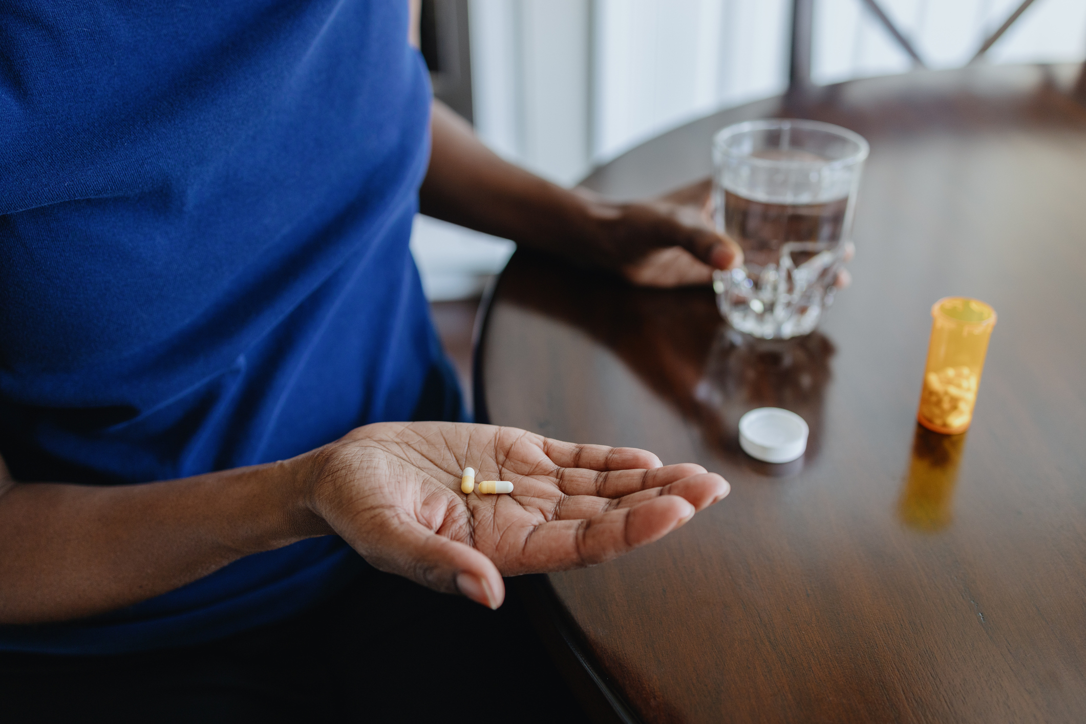 Woman taking a prescription pill