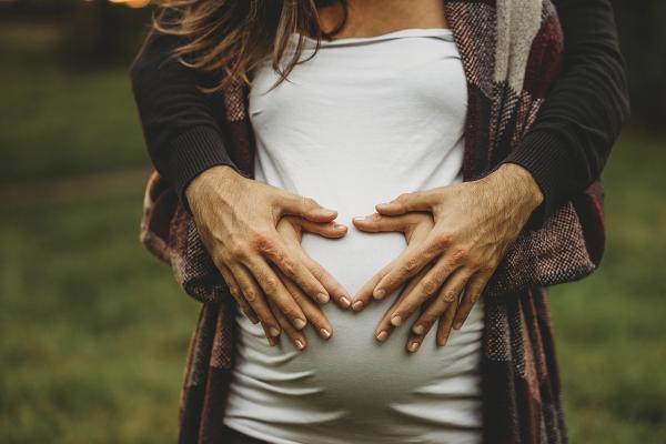 Pregnant woman holding her belly