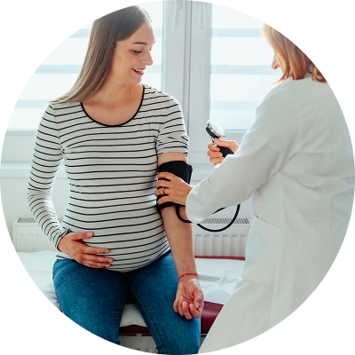pregnant woman getting her blood pressure checked
