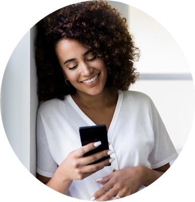 smiling woman looking at phone