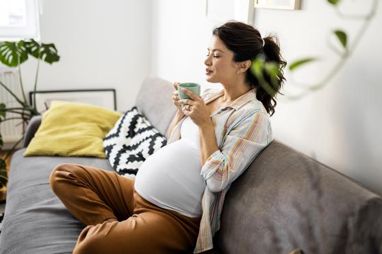 Pregnant women drinking a hot beverage