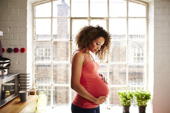 Pregnant woman holding belly