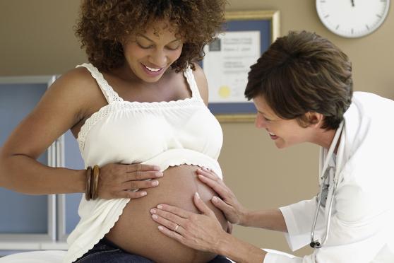 Pregnant woman getting a checkup at the doctors
