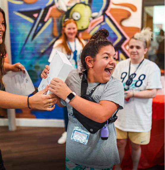A youth attending the Sideline the Stigma event on Aug. 26, 2023, was surprised with a prize she won in a raffle.