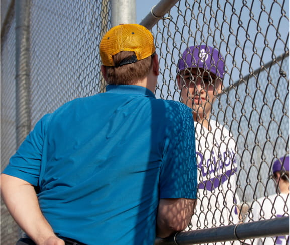 A coach talking to an athlete.