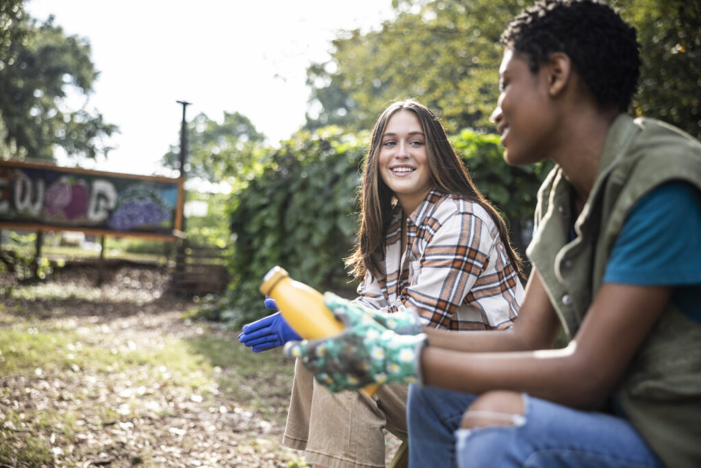 Young women hanging out in community garden